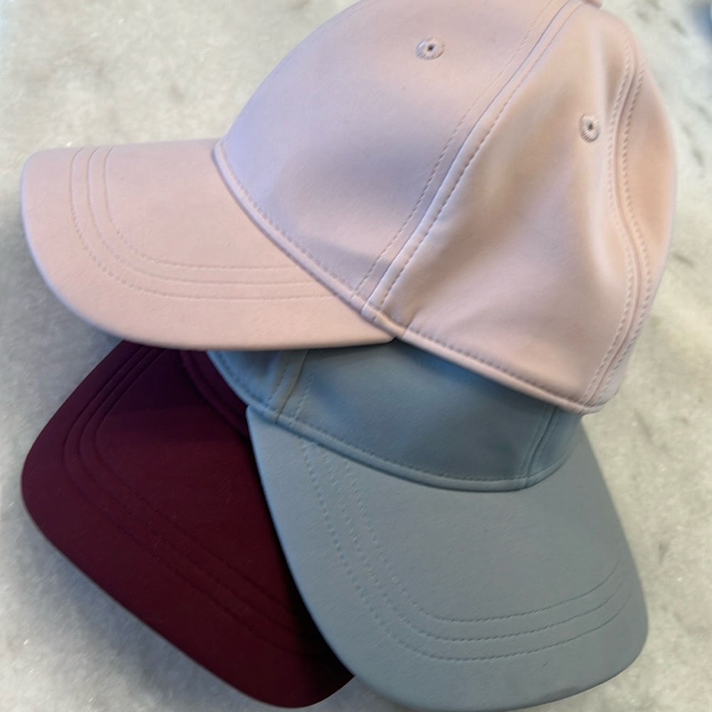 Three Lululemon caps. Like new. No wear or tear.